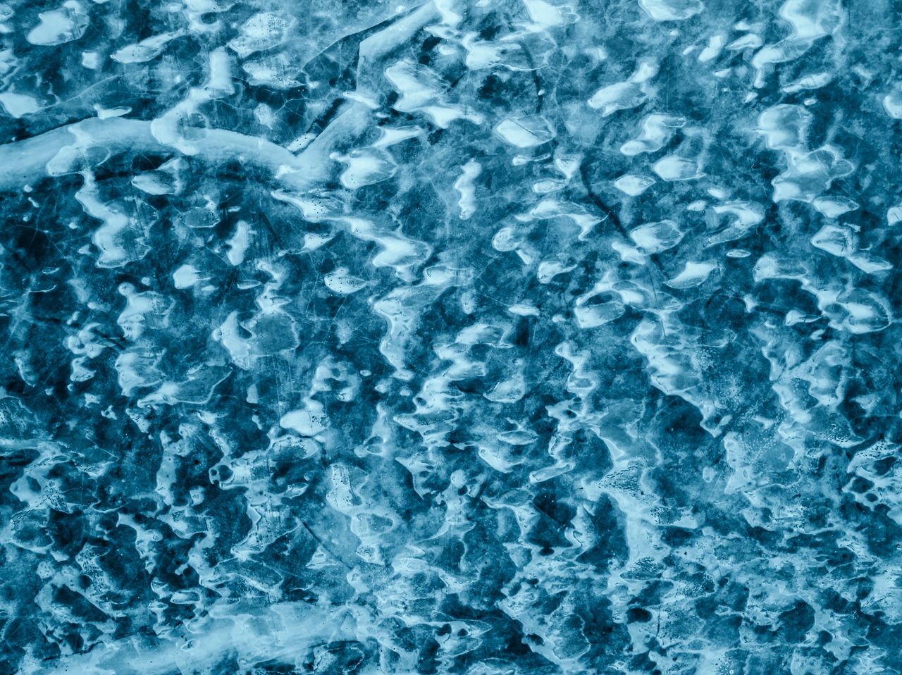 A frozen lake from above creating cool patterns